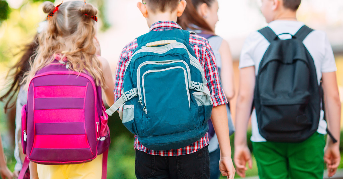 School kids with backpacks heading to school.